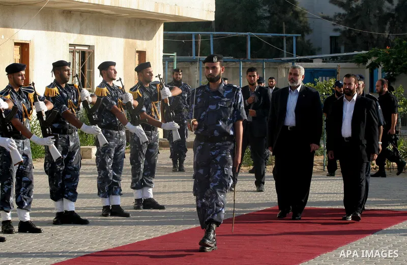 Palestinian Prime Minister of hamas Ismail Haniya attends a military parade at a governmental compound that was destroyed during Israel's December-January offensive on the Gaza Strip, in Gaza City on August 13, 2009 to h...