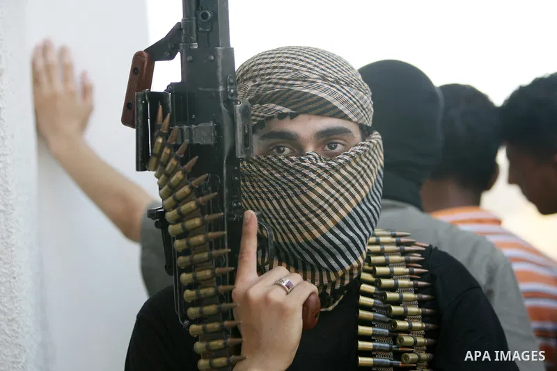 Gunmen from the radical Palestinian Islamist group "Jund Ansar Allah" walk near a mosque after the Friday prayers in the southern Gaza Strip town of Rafah on August 14, 2009. Around 15 Palestinians were hurt in the area...