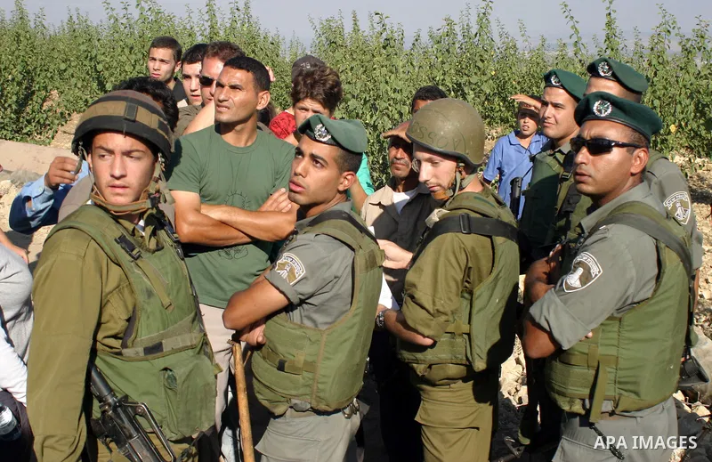 Palestinians and foreign activists argue with Israeli soldiers during a protest in the village of Safa near the West Bank Jewish settlement of Bat Ayin, Saturday, Aug. 15, 2009. The demonstrators were protesting against...