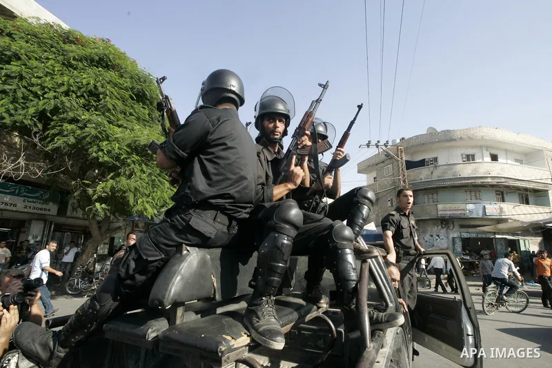 Palestinian Hamas security forces keep watch outside a mosque in Rafah in the southern Gaza Strip on August 15, 2009 during the funeral of Hamas members killed in clashes with a radical Islamist sect. At least 24 people...