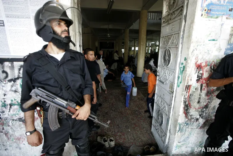 Palestinian Hamas security forces keep watch outside a mosque in Rafah in the southern Gaza Strip on August 15, 2009 during the funeral of Hamas members killed in clashes with a radical Islamist sect. At least 24 people...