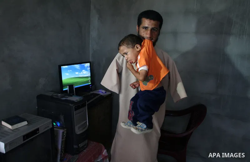 KHAN YOUNIS, Aug. 16, 2009 -- Abdurrahman, 21, is seen at his house in southern Gaza Strip town of Khan Younis. Born without arms, the university student can open his books, write, use the computer, eat and drink and eve...