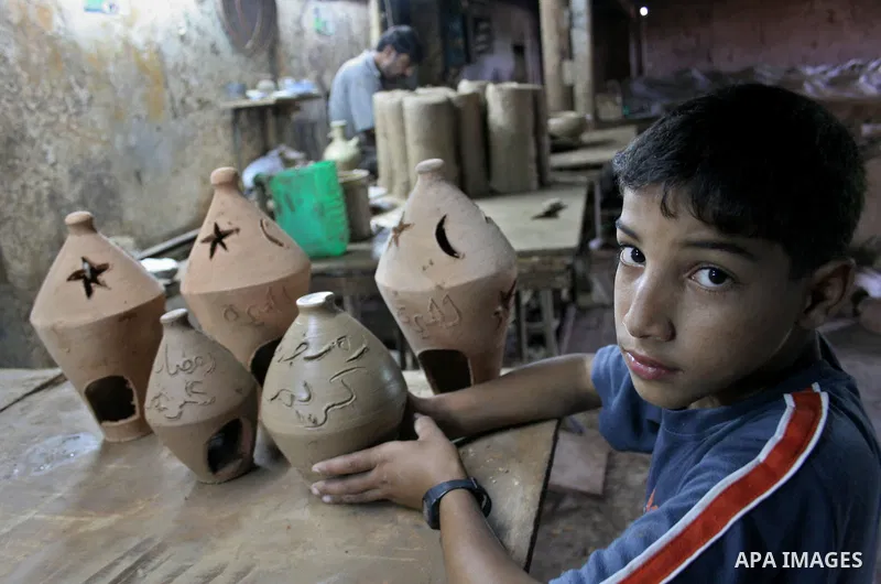 A Palestinian potter makes a clay lantern at his workshop in Gaza City on Aug 18, 2009, ahead of the start of the holy month of Ramadan during which Muslims fast from dusk to dawn and give alms to the poor. The Arabic ex...
