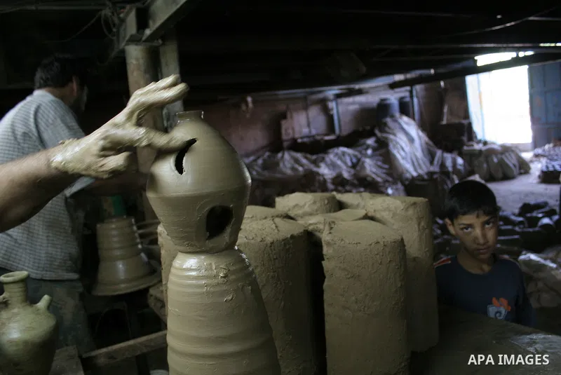 A Palestinian potter makes a clay lantern at his workshop in Gaza City on Aug 18, 2009, ahead of the start of the holy month of Ramadan during which Muslims fast from dusk to dawn and give alms to the poor. The Arabic ex...