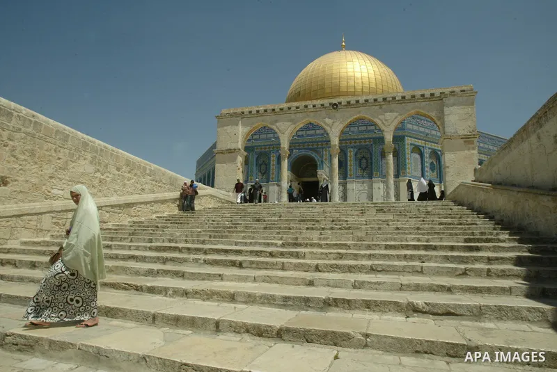 A Palestinians walks in front of the dome of the rock at Alaqsa mosque during the memorial ceremony of burning Alaqsa mosque in 1969 and one day before starting of the Islamic holyest fasting month Ramadan in the old cit...