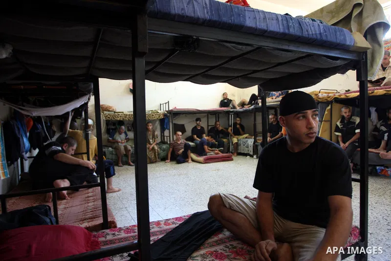 Palestinian prisoners stand inside the new Hamas police controlled jail in Gaza City 21 August 2009. A Hamas jail was built after Gaza's main prison was destroyed during the three-week offensive Israel launched against H...