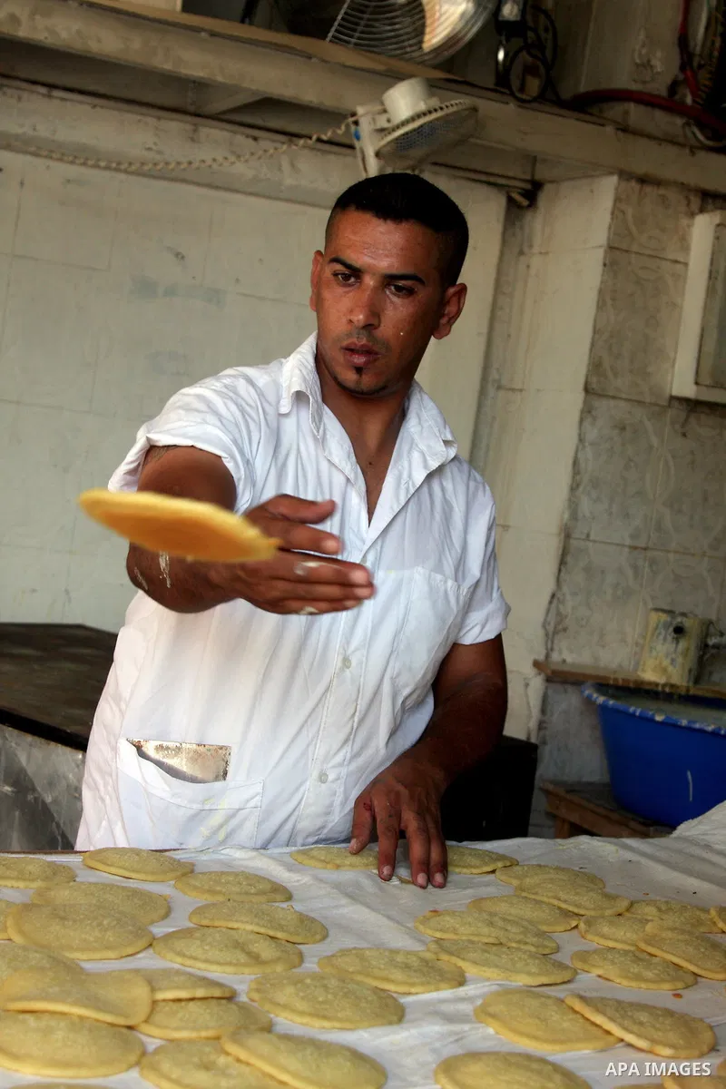 A Palestinian sweet maker prepares pancake called "katayef" on the Second day of Ramadan, the holy fasting month, in the West Bank city of Ramallah on Aug 23, 2009. During Ramadan, Muslims are required to abstain from fo...
