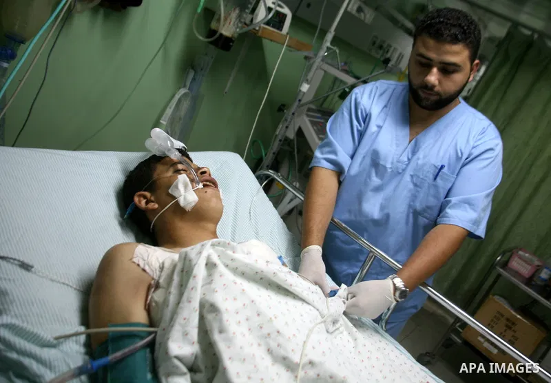 A medic adjusts the bed of a wounded Palestinian youth at a hospital in Beit Lahia in the northern of Gaza Strip on August 24, 2009. One Palestinian man was killed and another wounded by Israeli gunfire on the northern e...