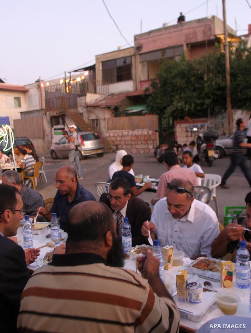 A Palestinian Hanon family breaks their fasting at the street after they were evicted from their houses in Sheikh Jarah during the third day of the holy month of Ramadan in Jerusalem August 24, 2009. Photo by Mahfouz Abu...