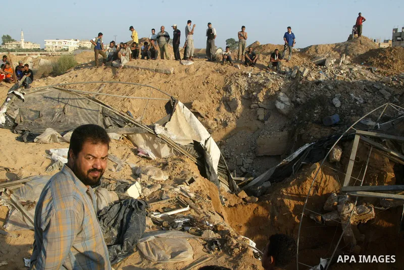 Palestinian relatives look outside the tunnel during the search by the Palestinian rescue teams to retrieve a missing person under the land between Egypt and Gaza in Rafah, southern Gaza Strip on August 25, 2009. an Isra...