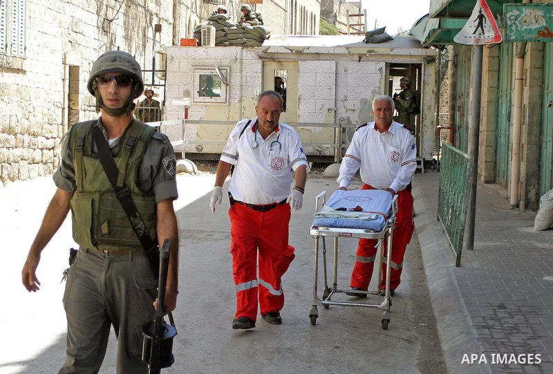 An Israeli soldiers take a positions after Palestinian man who tried to attack a soldier with a knife at an Israeli checkpoint near the Jewish settlements of Beit Hadasa and Tal Rumeida, in the West Bank city of Hebron A...