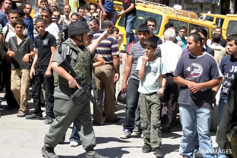 An Israeli soldiers take a positions after Palestinian man who tried to attack a soldier with a knife at an Israeli checkpoint near the Jewish settlements of Beit Hadasa and Tal Rumeida, in the West Bank city of Hebron A...