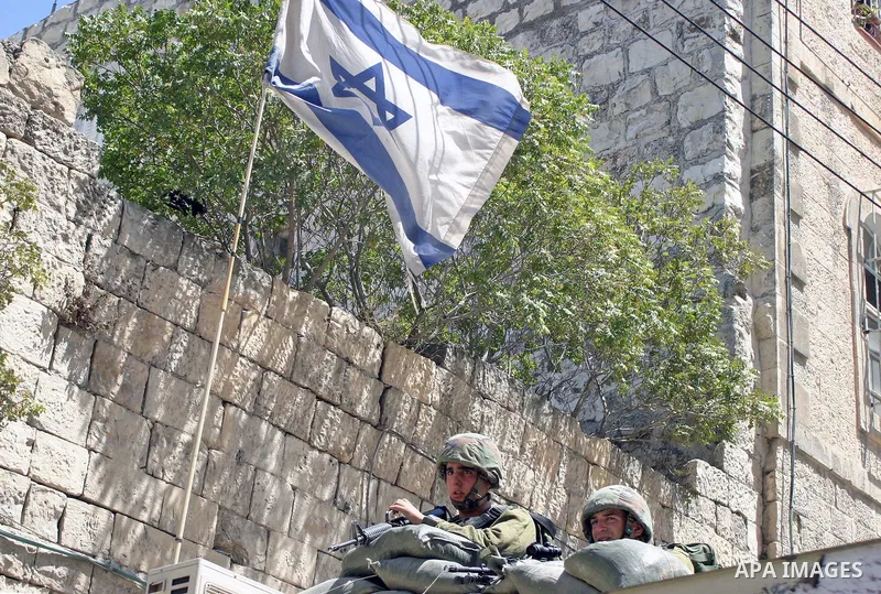 An Israeli soldiers take a positions after Palestinian man who tried to attack a soldier with a knife at an Israeli checkpoint near the Jewish settlements of Beit Hadasa and Tal Rumeida, in the West Bank city of Hebron A...