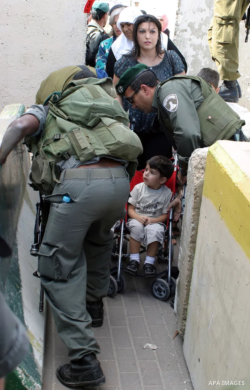 Palestinian women wait to cross an Israeli checkpoint in the West Bank city of Bethlehem on Aug 28, 2009, as they try to reach the al-Aqsa mosque in Jerusalem on the first Friday of the Muslim holy month of Ramadan. Musl...