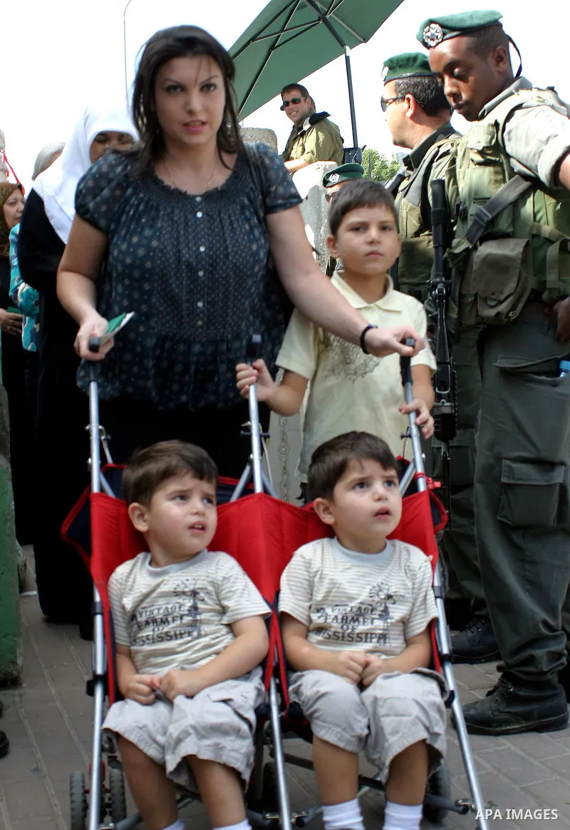 Palestinian women wait to cross an Israeli checkpoint in the West Bank city of Bethlehem on Aug 28, 2009, as they try to reach the al-Aqsa mosque in Jerusalem on the first Friday of the Muslim holy month of Ramadan. Musl...