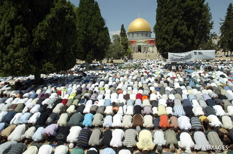 A Palestinians attend the first Friday prayers of the Muslim holy month of Ramadan in front of the Dome of the Rock on the compound known to Muslims as al-Haram al-Sharif (Noble Sanctuary) and to Jews as Temple Mount, in...