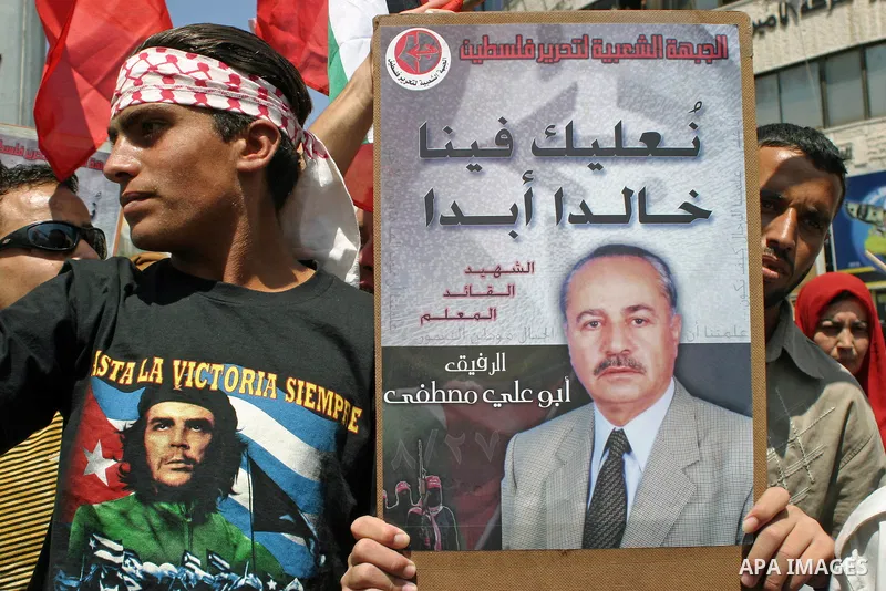 A supporters of the popular front for liberation Palestine, attends a rally to mark the eight anniversary of assassination the popular front secretary general Abu Ali Mustafa, in the West Bank city of Hebron August 29, 2...