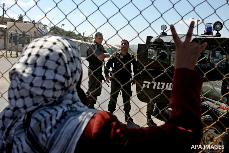 Palestinian demonstrators wave flags during a protest outside the Ofer military prison between Jerusalem and the West Bank town of Ramallah, calling for the release of prisoners, Monday, Aug. 31, 2009. Israel currently h...