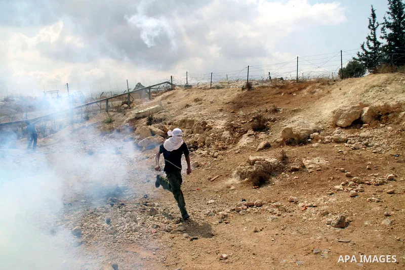 Palestinian and foreign protestors during a demonstration against Israel's controversial separation barrier in the West Bank village of Bilin near Ramallah on Sep 4, 2009.. Photo by Nedal Shtieh