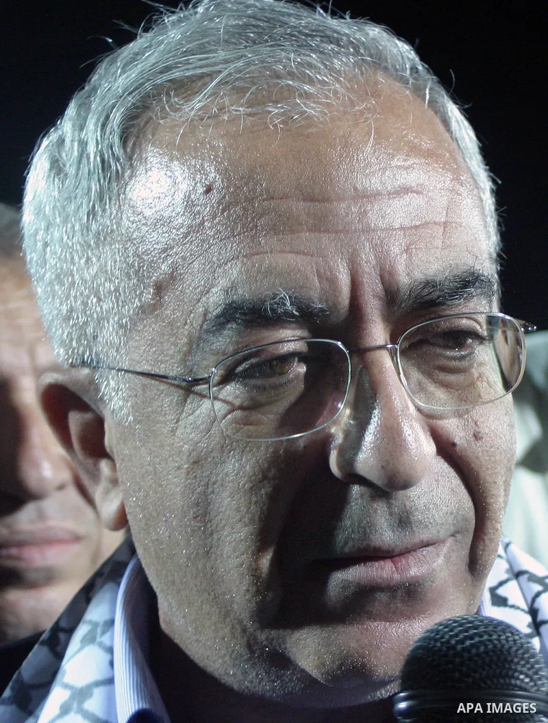 Palestinian prime minister Salam Fayyad gives a speech during Palestinian Olympic team and Jordanian Olympic team during a friendly game at Al-Hussein stadium during the opening ceremony of a new football field in the We...