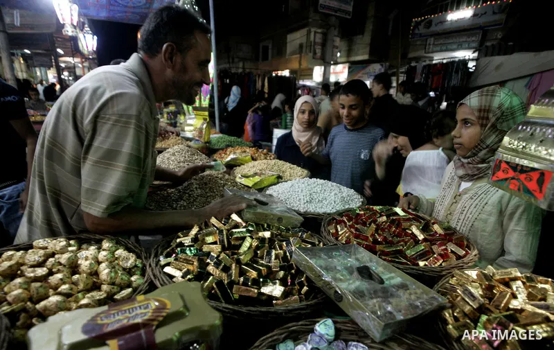 Palestinians shop in the main market during preparations for the Eid Al-Fitr feast in Rafah, southern Gaza Strip on September 17, 2008. Muslims around the world are preparing to celebrate the Eid Al-Fitr holiday, which m...
