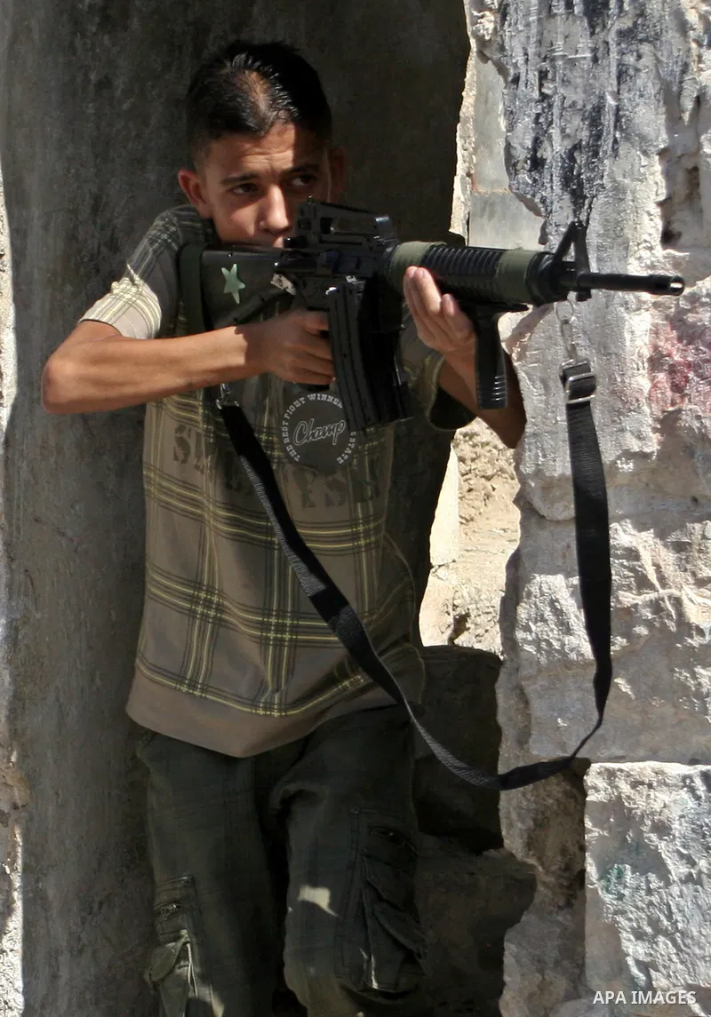 Palestinian boys play with toy guns to celebrate Eid al-Fitr during the third day of the holiday of Eid al-Fitr in West Bank the town of Nablus on September 22, 2009. Eid Al-Fitr marks the end of Ramadan, the month of fa...