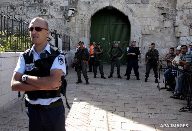 Israeli police take positions during clashes with Palestinians in Jerusalem's Old City, Sunday, Sept. 27, 2009. Israeli police used stun grenades Sunday to disperse Palestinians at a volatile Jerusalem site holy to Jews...