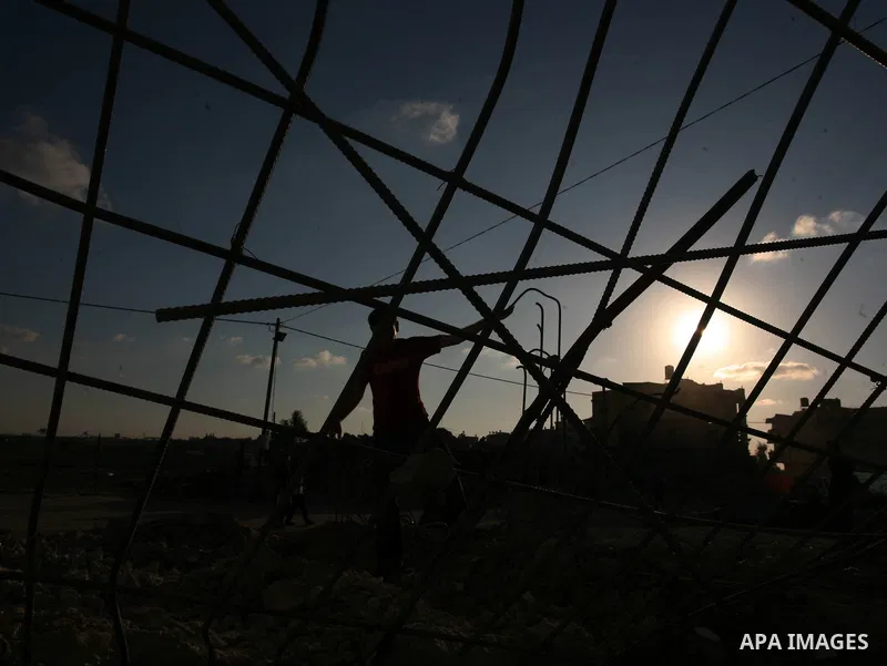 Palestinian man removes rubble from a house that was destroyed in January's Israeli military offensive, in Jabalia in the northern Gaza Strip, on October 1, 2009. Israel warned that the UN Human Rights Council would stri...