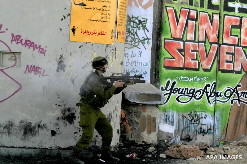 Israeli soldiers take position during clashes with Palestinians at Qalandiya checkpoint near the West Bank city of Ramallah October 5, 2009. Police flooded into Jerusalem's Old City following clashes with Palestinians ne...
