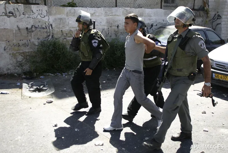 Israeli border policemen detain Palestinian boy during clashes in the East Jerusalem neighbourhood of Ras al-Amud on October 5, 2009. Israeli police and Palestinian protestors clashed near Al-Aqsa, a flashpoint site sacr...