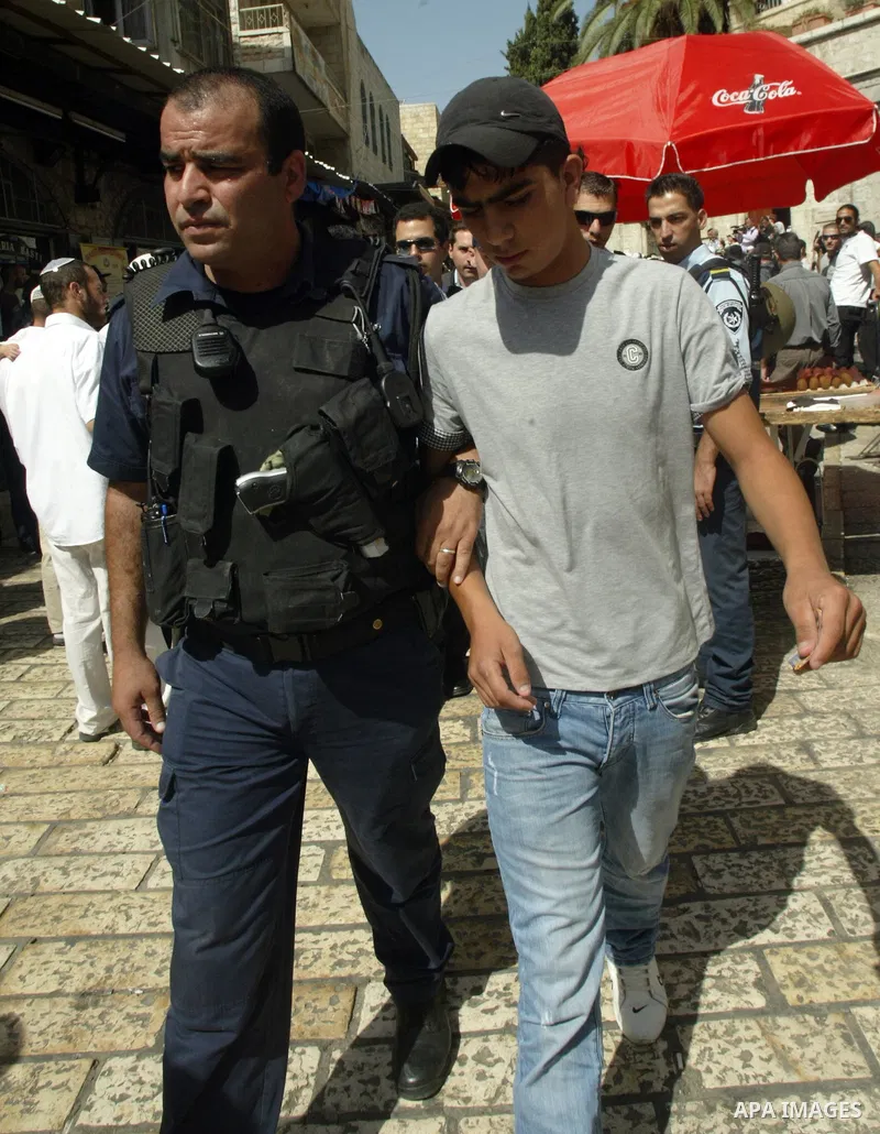 Israeli border policemen detain Palestinian youth after clashes in the East Jerusalem neighbourhood of Ras al-Amud on October 10, 2009. Israeli police and Palestinian protestors clashed near Al-Aqsa, a flashpoint site sa...
