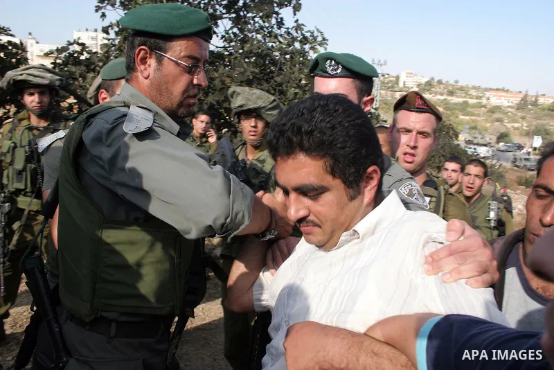 Palestinians, Israelis and foreign activists attend a protest against Jewish settlement within the West Bank near Kiryat Arba settlement in the West Bank city of Hebron October 23, 2009. Photo by Najeh Hashlamoun