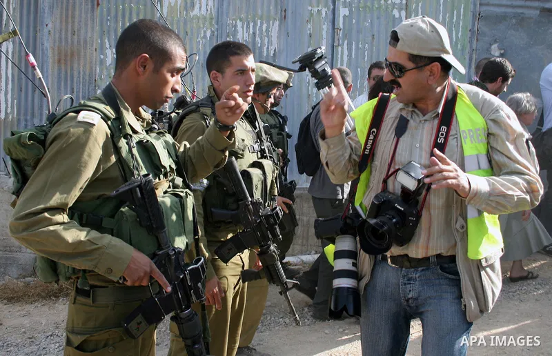 Palestinians, Israelis and foreign activists attend a protest against Jewish settlement within the West Bank near Kiryat Arba settlement in the West Bank city of Hebron October 23, 2009. Photo by Najeh Hashlamoun