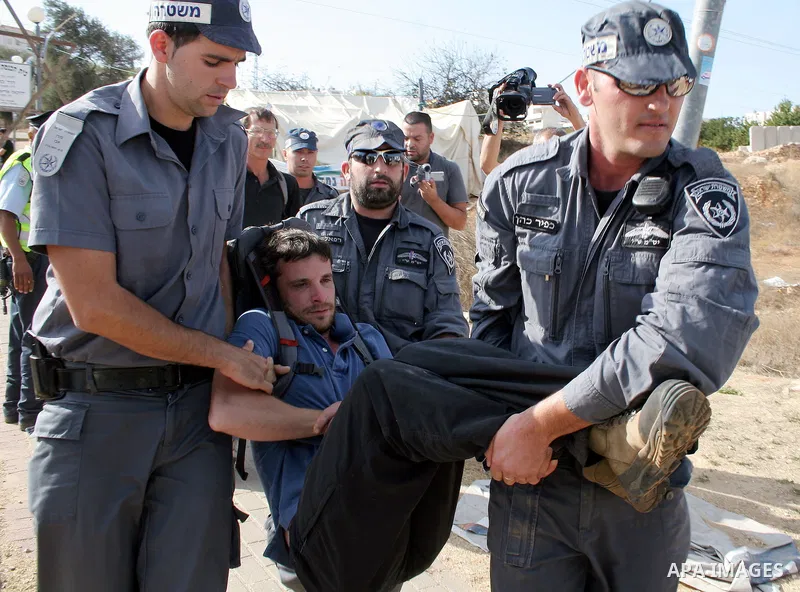 Israeli soldiers and border police arrest Palestinians, and foreign activists during a demonstration against settlements in the West Bank city of Hebron on October 23, 2009. Photo by Najeh Hashlamoun .