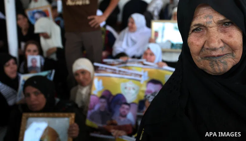 Palestinians hold pictures of their relatives jailed in Israeli prisons during a protest in Gaza City on Nov2, 2009 to call for their release. Currently Israel is holding 11,000 Palestinians in its jails. Photo By Mohamm...
