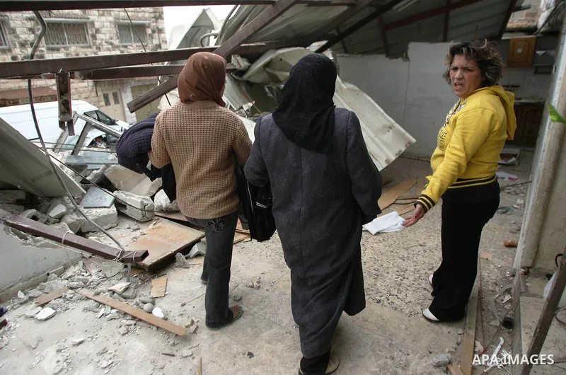 A Palestinians inspect the rubble of their house follow an Israeli bulldozer demolished it that was built without a construction permit, in the Arab Jerusalem city on Nov 2, 2009. photo by Muammar Awad