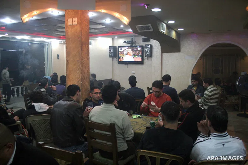 Palestinian youths watching the match between Egypt and Algeria during their World Cup 2010 qualifying soccer match in Cairo, in the West Bank city of hebron on Nov 14, 2009.Photo by Najeh Hashlamoun