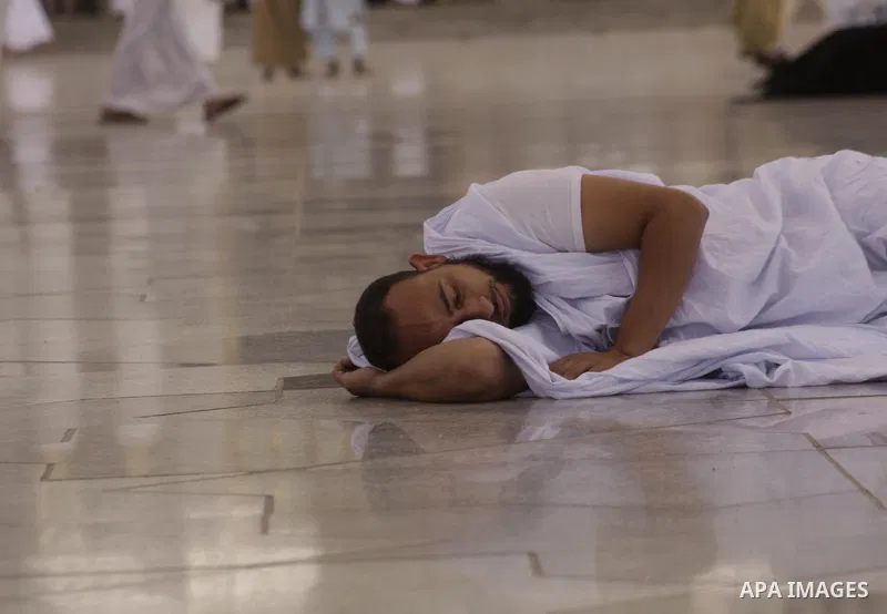 Muslim pilgrim take rest in the courtyard of the Prophet Mohammed Mosque in the Saudi holy city of Medina on November 13, 2009. More than three million Muslims are expected to converge on the holy cities of Mecca and Med...