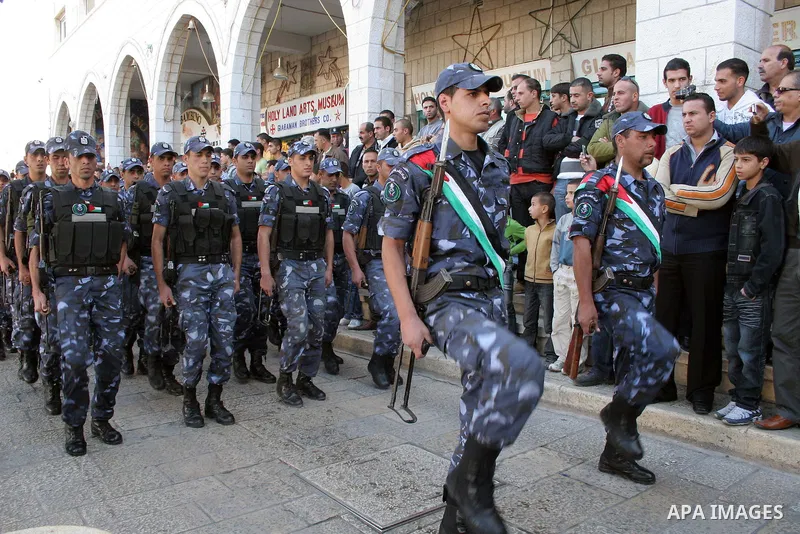 Palestinians watch a march, marking a symbolic declaration of independence, in front of the Church of Nativity in the West Bank town of Bethlehem, Sunday, Nov 15, 2009. Palestinians have marked Nov. 15 as their Independe...