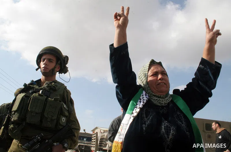 Israeli soldiers and Israeli border policemen stand guard behind razor-wire as Palestinian , Israeli activists and International activists during a rally against Israel's separation barrier in the West Bank village of al...
