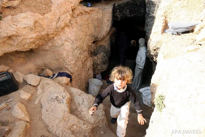 Palestinian child stands outside a cave in a mountainous area outside the southern town of Yatta near Hebron in the occupied West Bank on December 5, 2009. Palestinian residents of the area have returned to their lands w...
