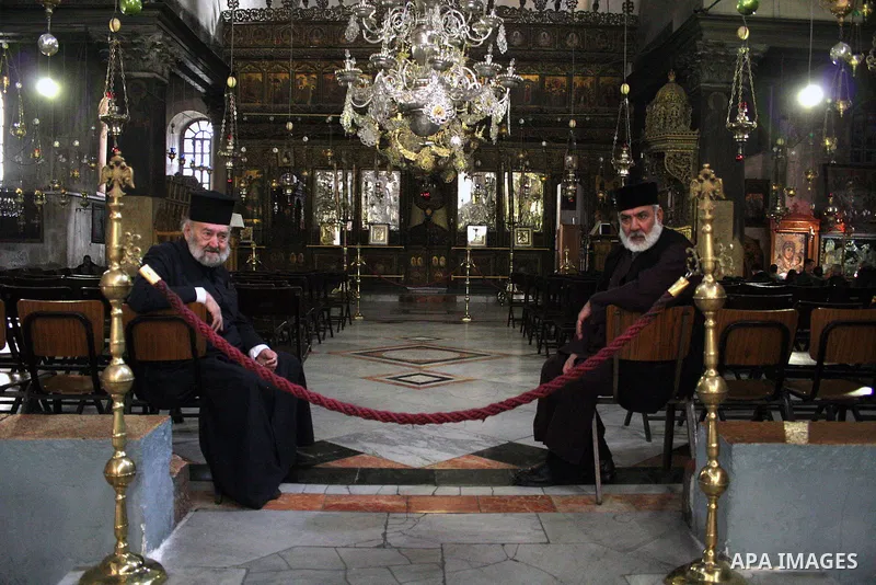 Catholic priests sit in the Church of the Nativity, the site revered as the birthplace of Jesus, in the West Bank town of Bethlehem, 06 December 2009.The church is built over the grotto where Christians believe the Virgi...