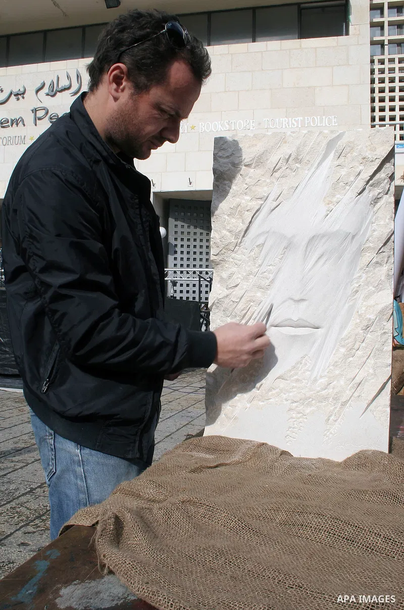 An Italian artist from the Madonnari Neapolitan School works on a sculpture outside the Church of the Nativity in the biblical West Bank city of Bethlehem on December 8, 2009. The traditional birthplace of Jesus Christ i...