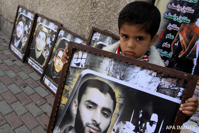 Palestinians hold pictures of their relatives jailed in Egyptian prisons during a protest in Gaza City on Dec 10, 2009 to call for their release. Photo By Mohammed Asad