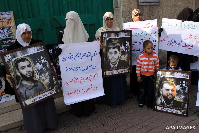 Palestinians hold pictures of their relatives jailed in Egyptian prisons during a protest in Gaza City on Dec 10, 2009 to call for their release. Photo By Mohammed Asad