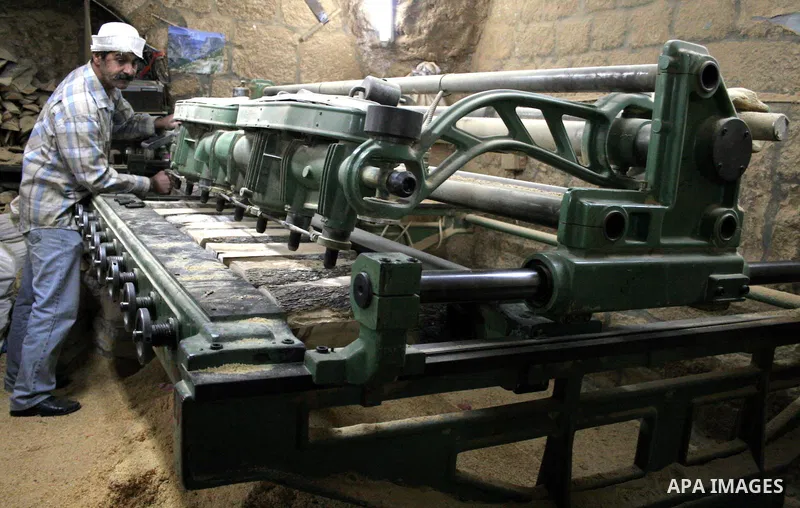 A Palestinian carpenters operates a machine carving wooden effigies of the the Holy Family in a workshop in the West Bank town of Bethlehem December 11, 2009, ahead of Christmas. Photo by Najeh Hashlamoun