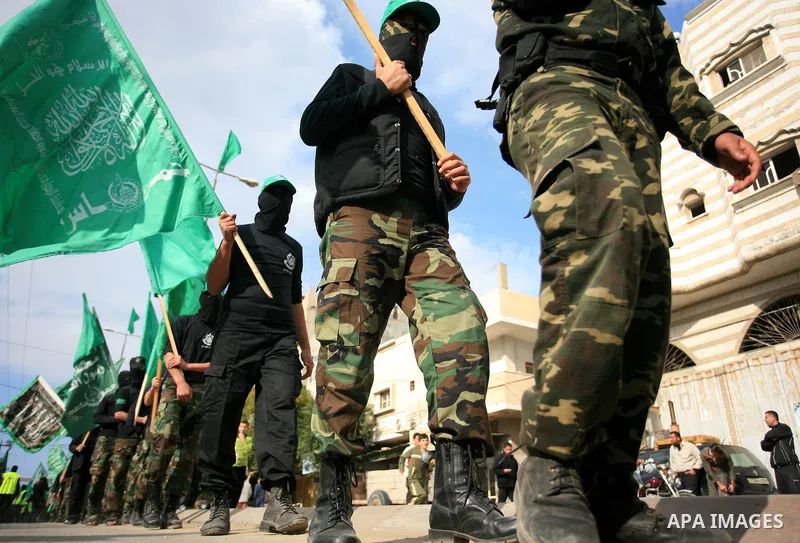 Palestinian Hamas masked militants take part in a protest and a military parade in the central Gaza Strip, 11 December 2009. Israeli settlers vandalized a mosque in a northern West Bank village early 11 December, spray-p...