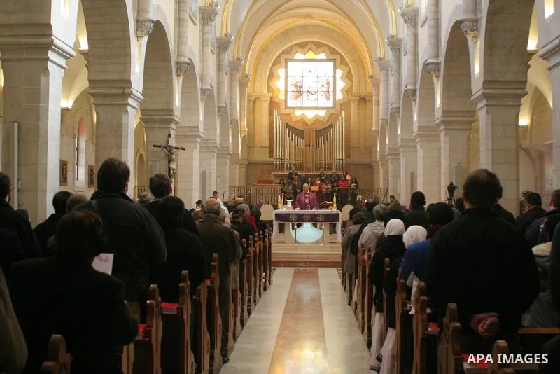 Palestinian worshippers attend a prayers in the Church of the Nativity in the West Bank town of Bethlehem Decembe 13, 2009.The church is built over the grotto where Christians believe the Virgin Mary gave birth to Jesus....