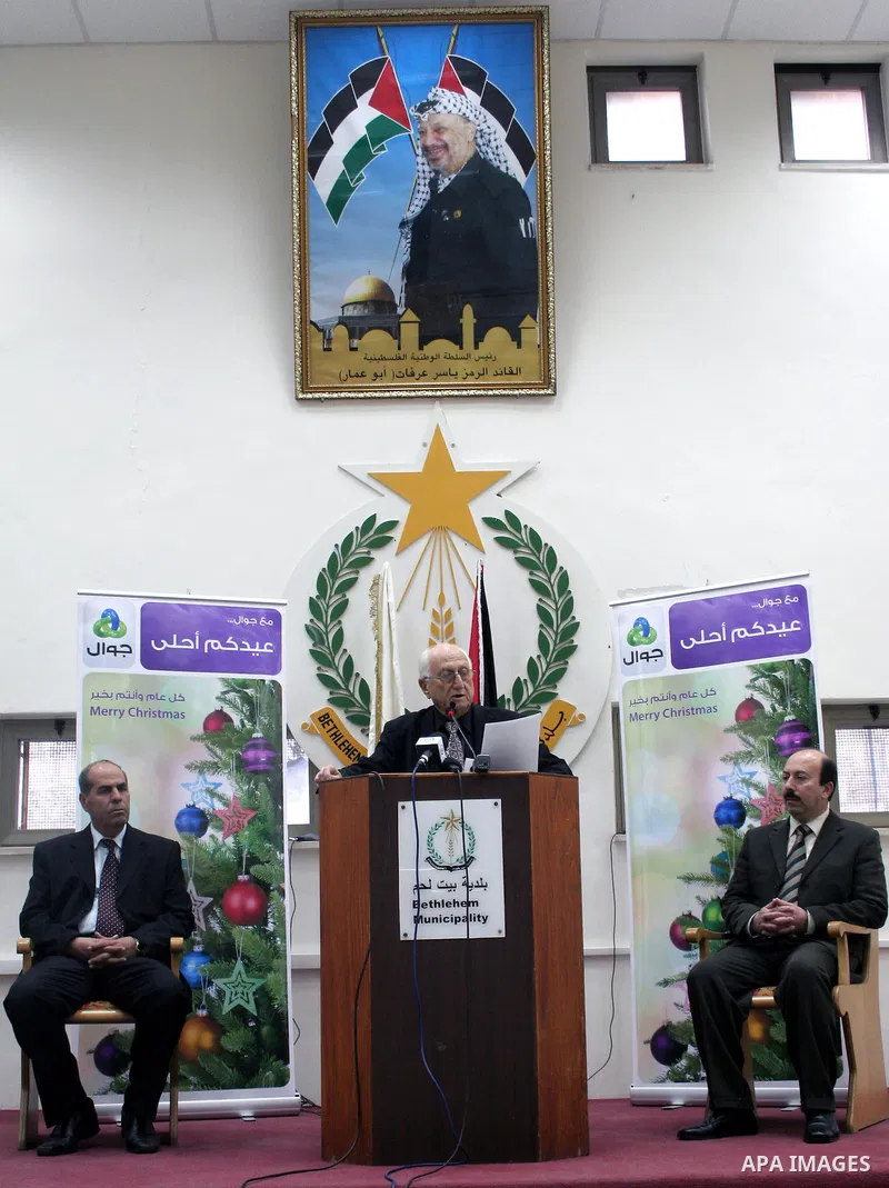 Bethlehem's Palestinian Mayor Victor Batarseh addresses Christian believers during a ceremony to light the biblical town's main Christmas tree on 15 December 2009 outside the Church of the Nativity. Scores of Christian p...