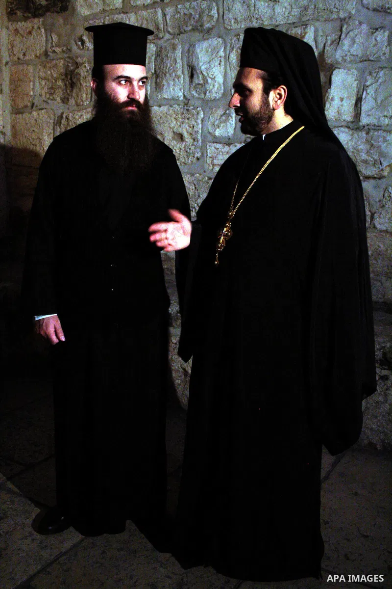 Greek Orthodox priest talking outside the Church of the Nativity in the West Bank city of Bethlehem on December 15, 2009. The traditional birthplace of Jesus Christ is preparing to receive Christian pilgrims to celebrate...